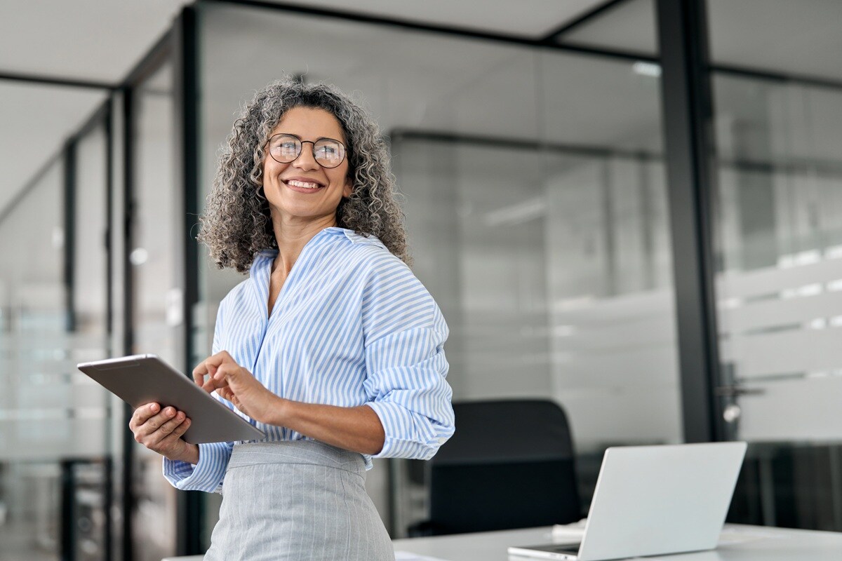 Lady in stripped top holding a tablet 