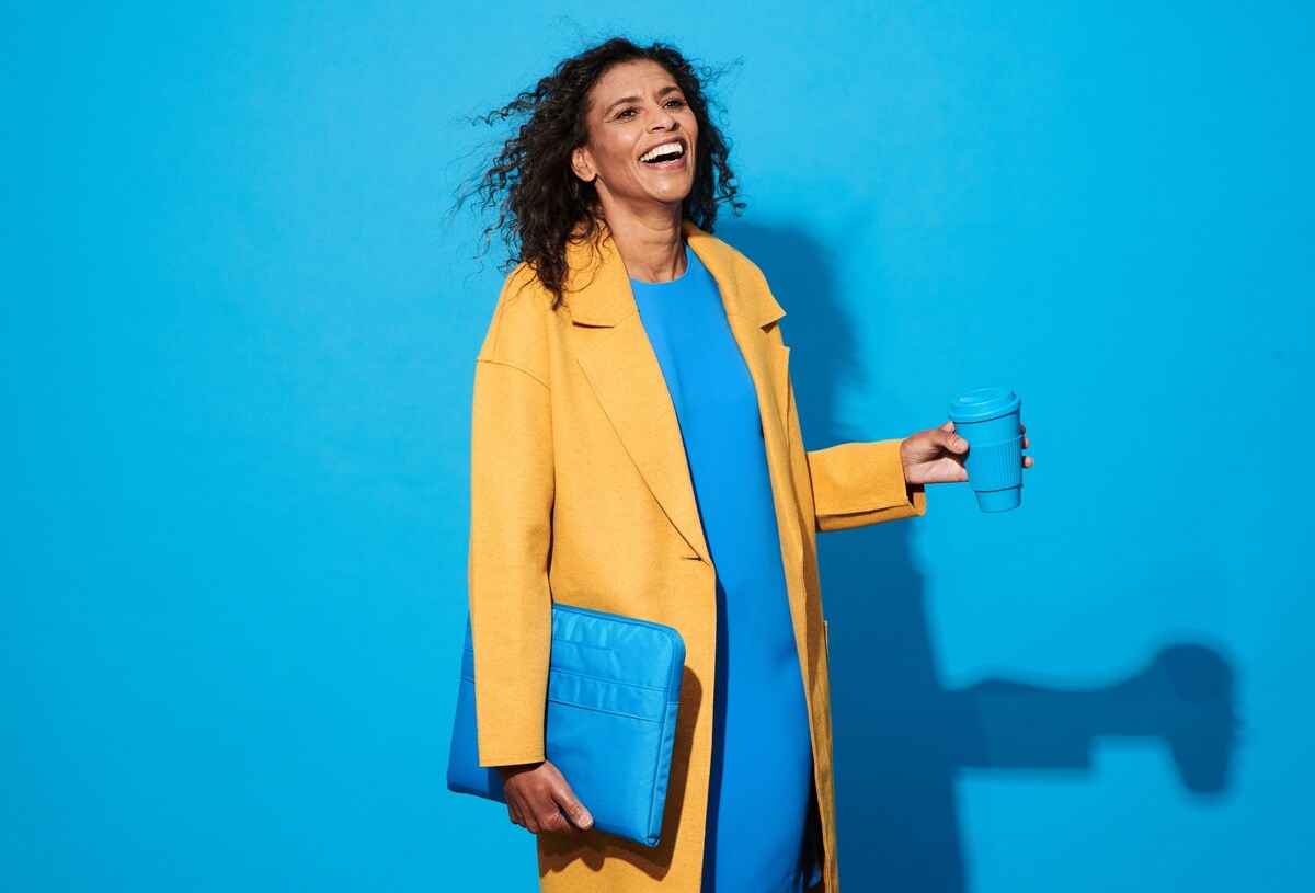 Lady wearing blue dress and yellow coat