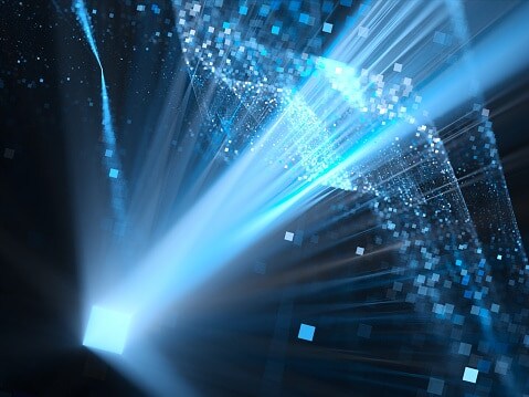 A beam of blue light shining into sky