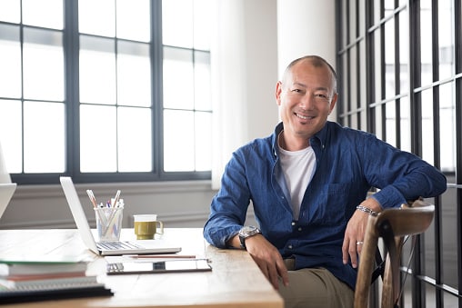 Man in blue shirt sitting in meeting room