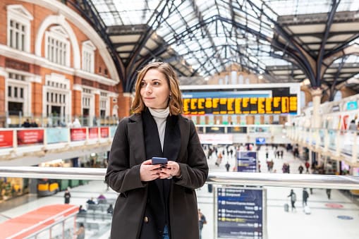 Lady standing in UK train station 