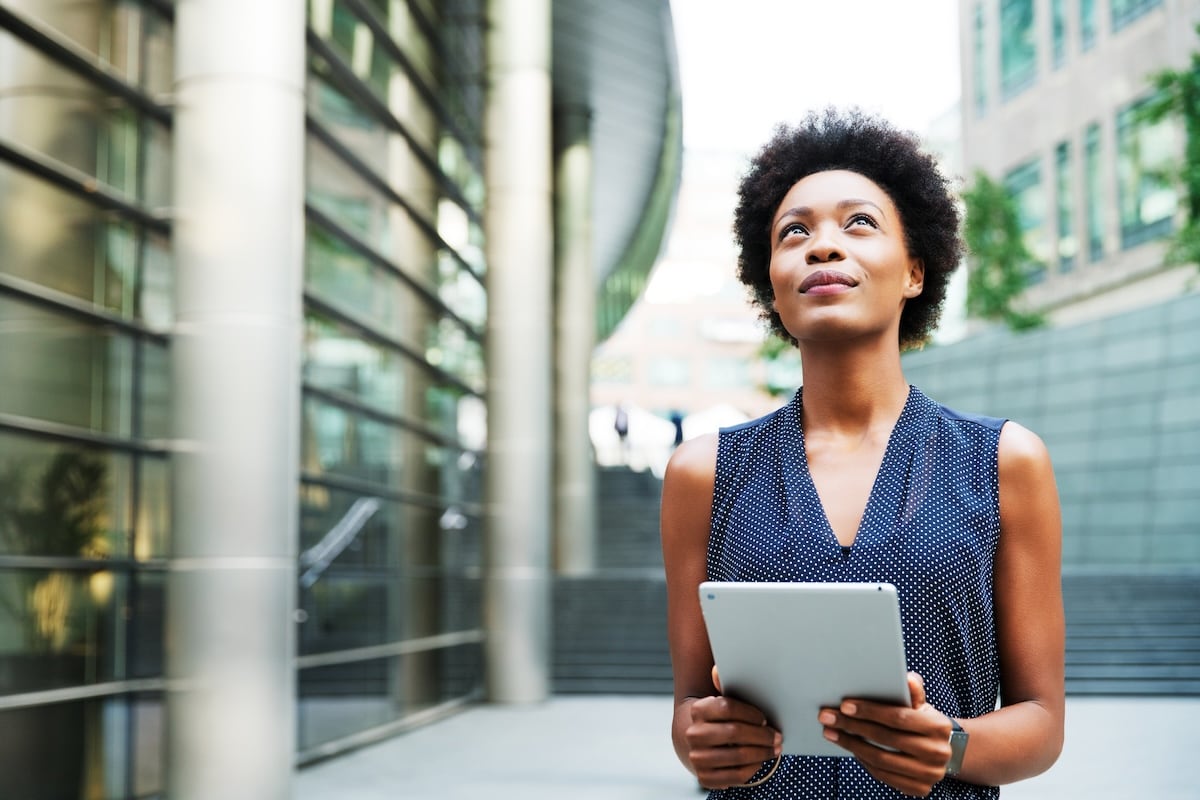 woman with ipad looking up