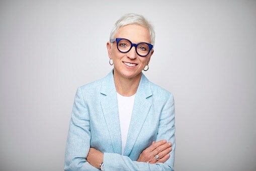 Lady with blue jacket and funky glasses