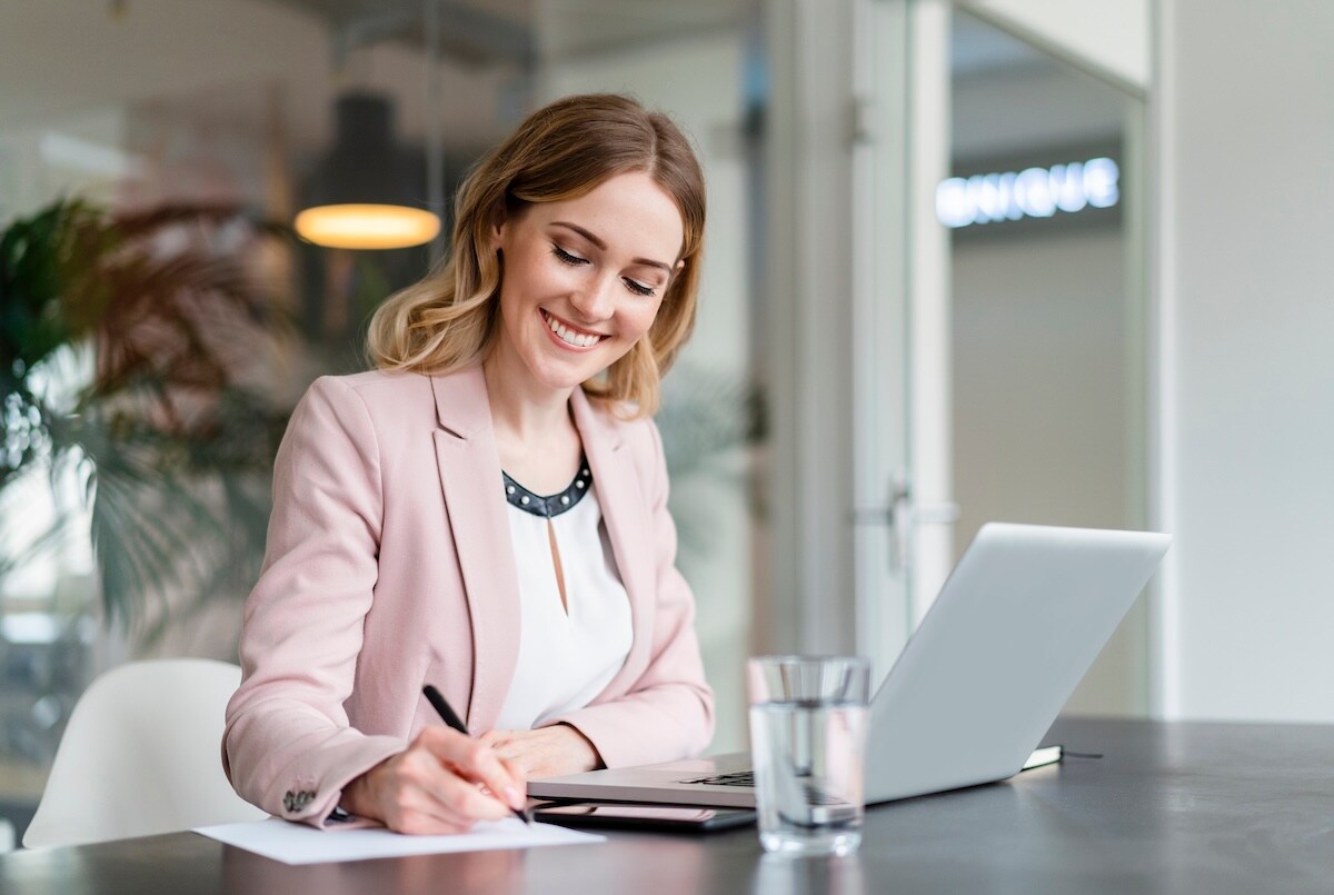woman smiling at computer