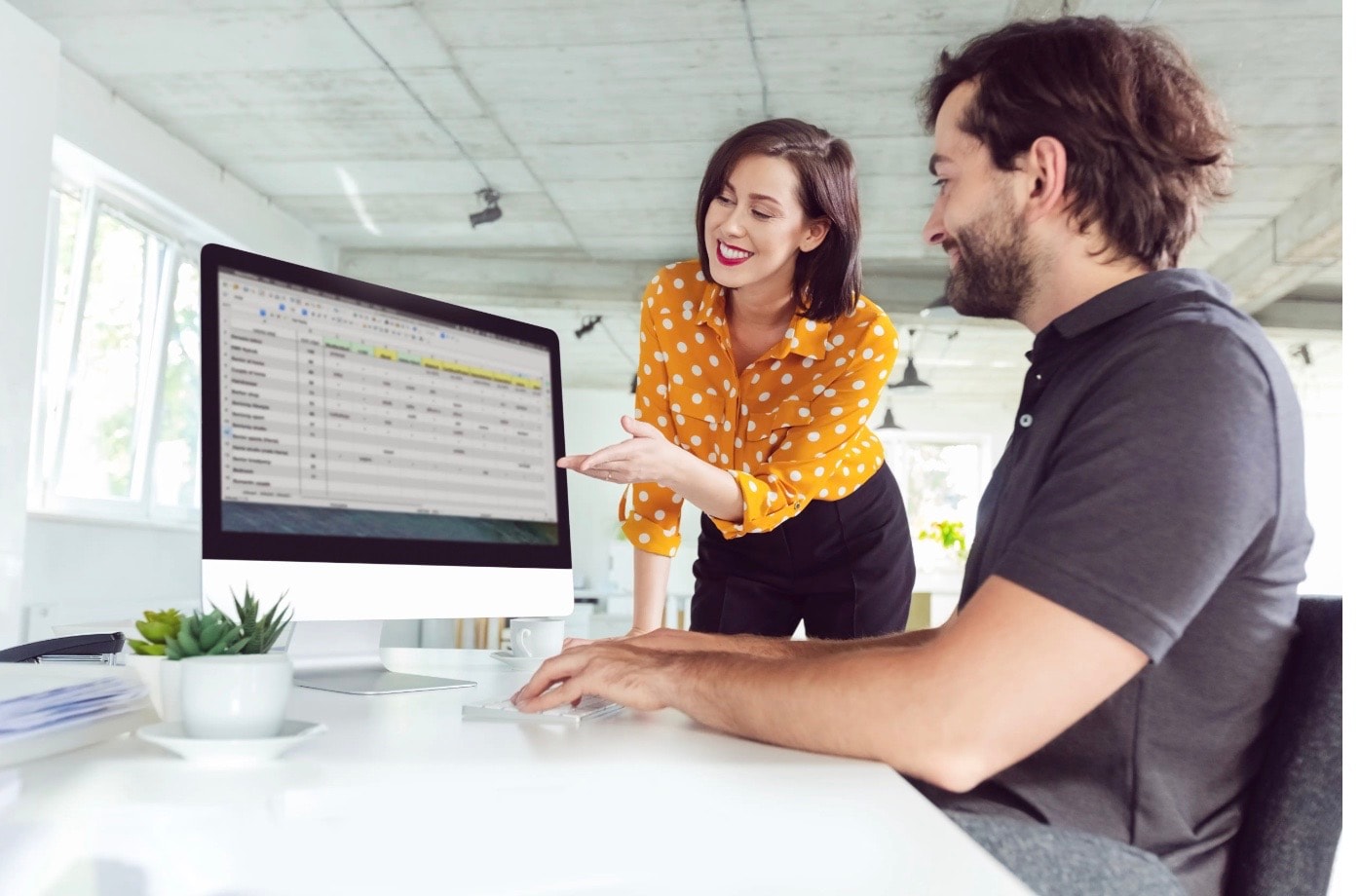 Man and woman looking at computer screen 